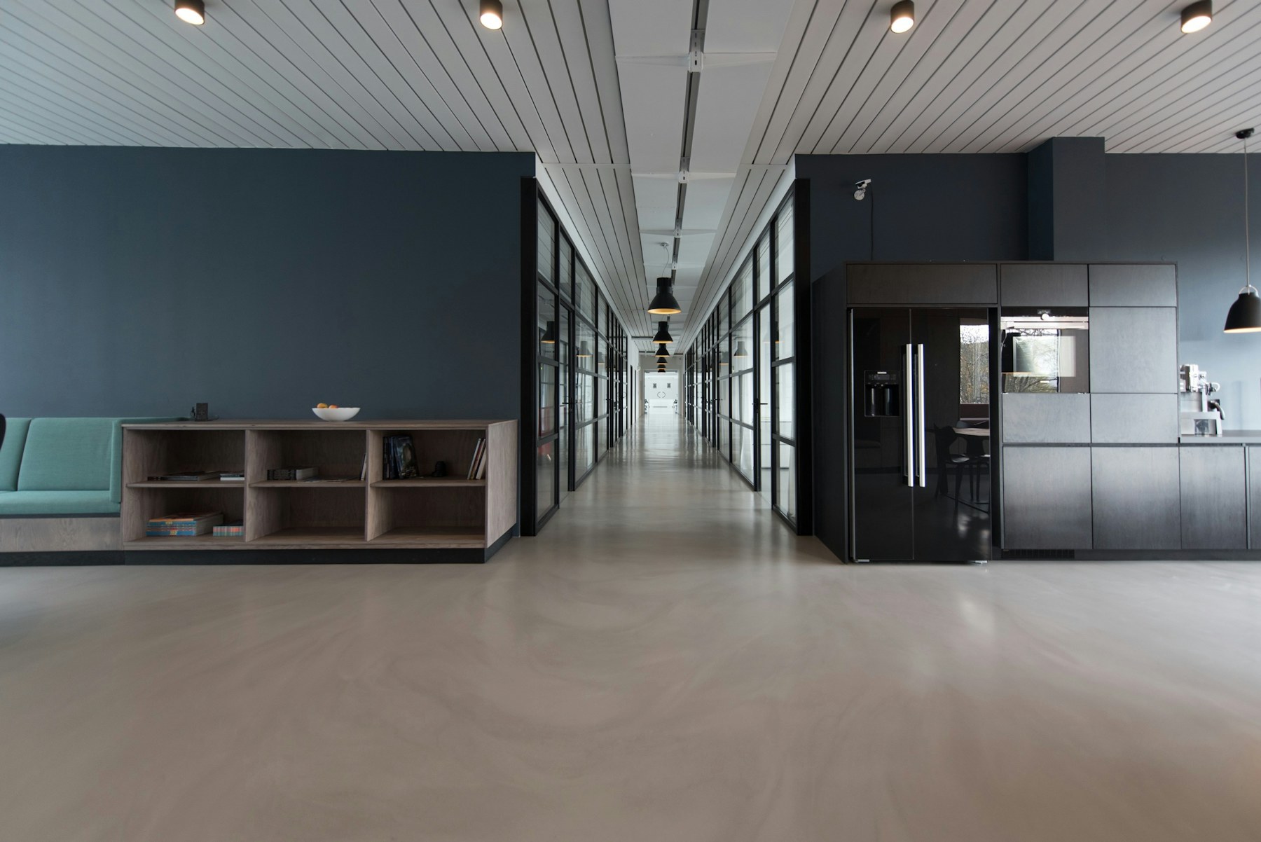Glass studio floors in motion, a kinetic band of light across a working marketing floor
