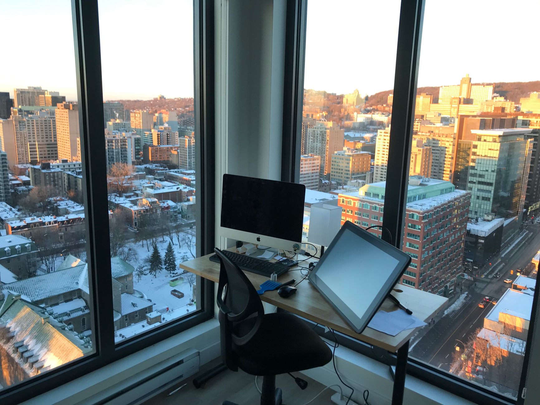 Desk at a high window overlooking a winter city